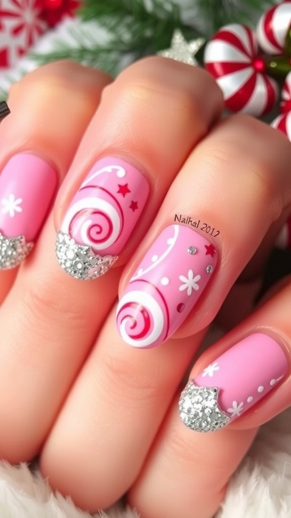 Pink Christmas nails with peppermint swirls and glitter accents.